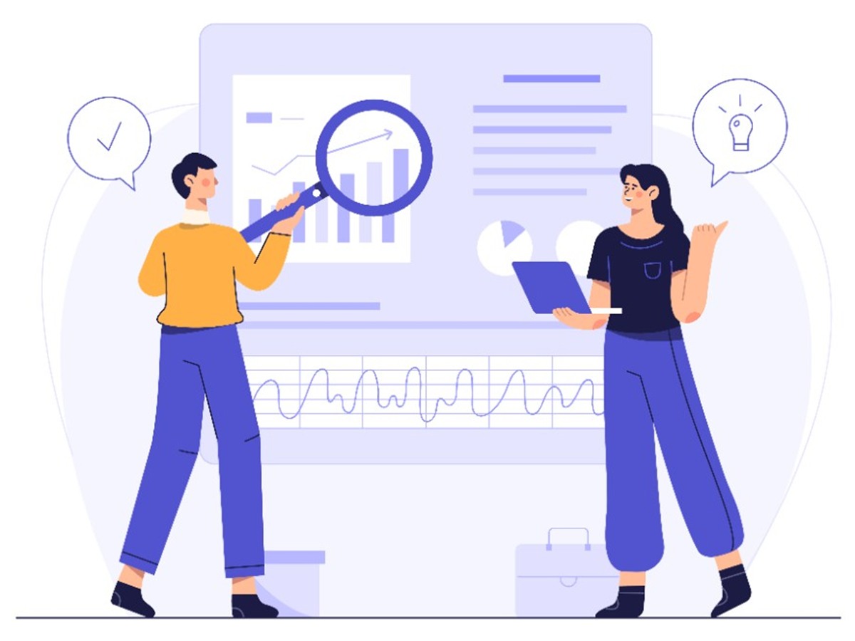 Two people reviewing charts on a large screen