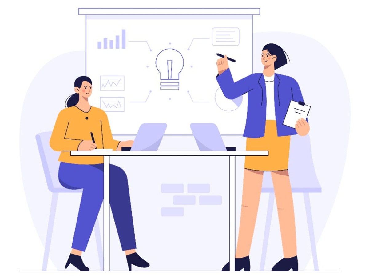 Two colleagues reviewing a presentation with charts